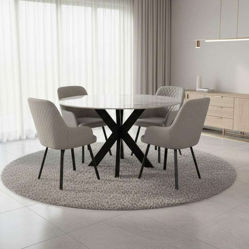 Modern dining room with a round table and chairs in a bright, minimalistic setting.