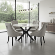 Modern dining room with a round table and chairs near large windows.