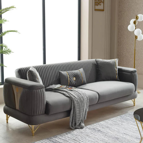 Gray sofa in a living room with a plant and coffee table.