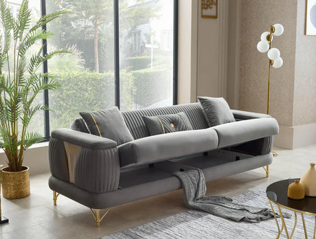Gray sofa in a modern living room with large windows and decorative elements.