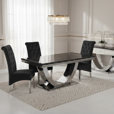 Modern dining room with a black marble table and chairs in a stylishly decorated room.
