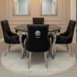 Dining room with round table and black chairs, chandelier, and mirrors on the wall.