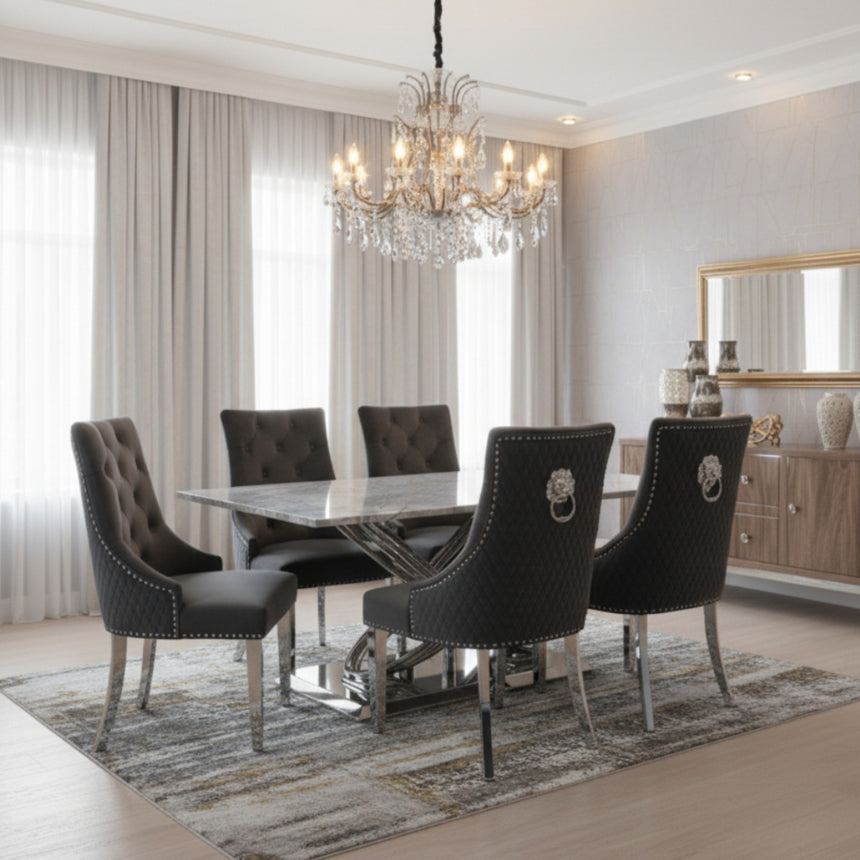 Dining room with a chandelier, table, and chairs.
