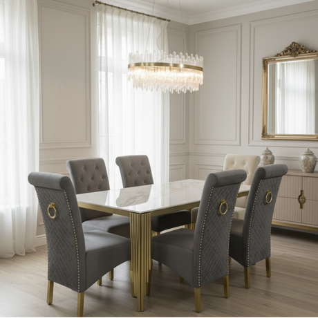 Elegant dining room with a table and chairs, chandelier, and decorative mirror.