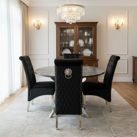 Dining room with black chairs, round table, and chandelier.