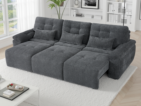 Gray electric sofa in a living room setting with decor elements.