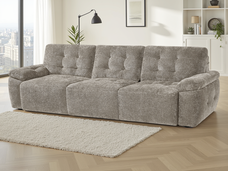 Gray sofa in a living room with large windows and decor