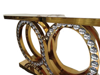 Decorative console table with gold finish and crystal embellishments on a white background