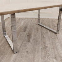 Freya dining table, chrome metal leg detail